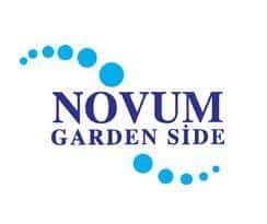 Logo for "Novum Garden Side" with the text in uppercase letters, "NOVUM" in blue and "GARDEN SIDE" in a slightly smaller size beneath. The design features a dotted aquamarine wave-like shape, arching from the top left to the bottom right corners. The background is white.